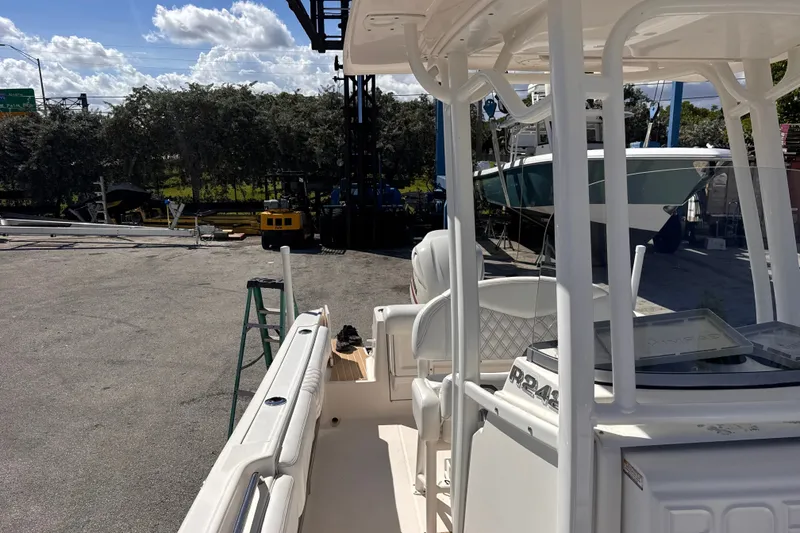 Slide: The Image of 2017 Robalo R242 Center Console boat docked under a clear blue sky. - 19