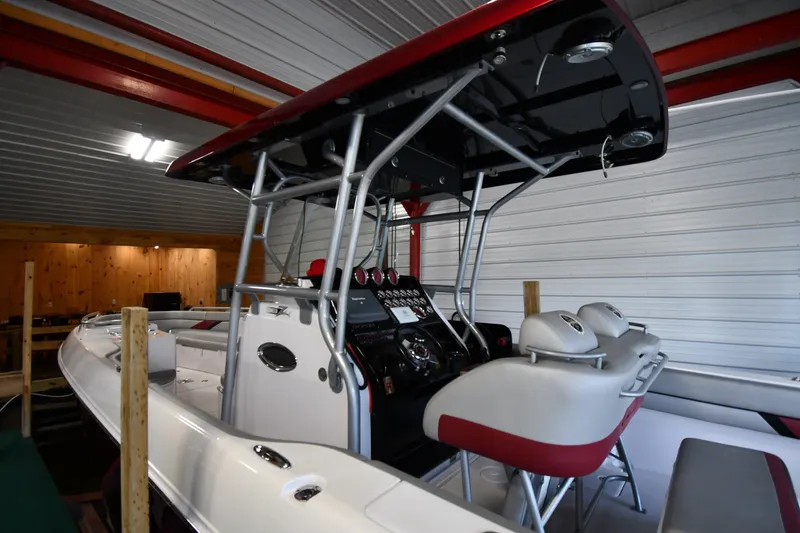 Slide: The Image of 2009 Donzi 38 ZFX Open boat interior with modern controls and seating in a garage. - 11
