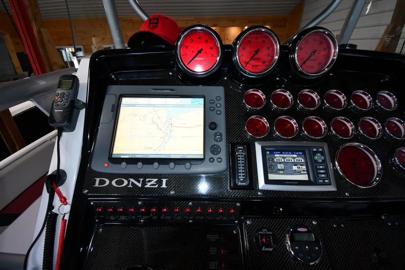 Slide: The Image of Dashboard of a 2009 Donzi 38 ZFX Open boat with navigation and gauges. - 19