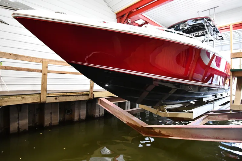 Slide: The Image of 2009 Donzi 38 ZFX Open boat in dry dock, showcasing sleek red and black hull design. - 4