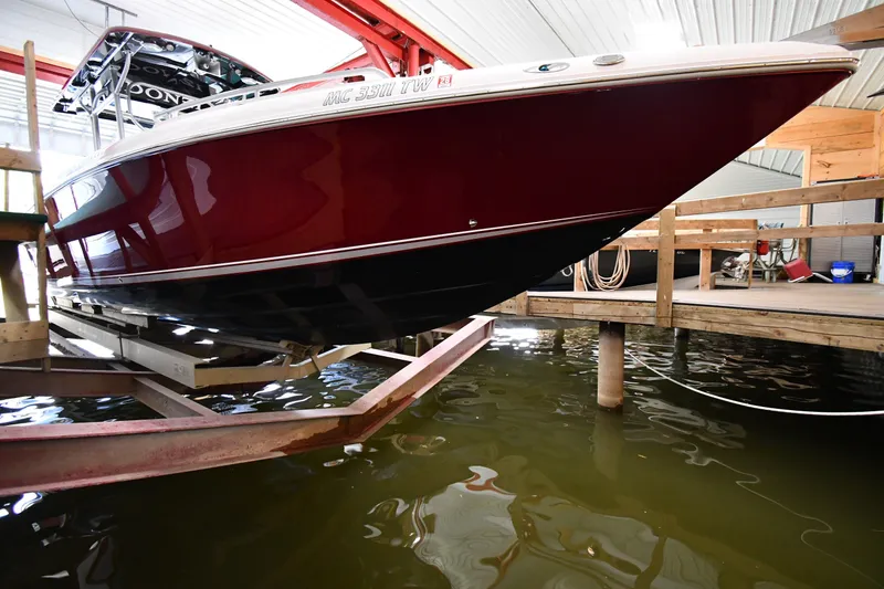 Slide: The Image of 2009 Donzi 38 ZFX Open boat in a docked position inside a boathouse. - 5