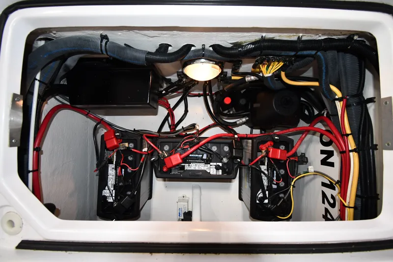 Slide: The Image of Electrical compartment of a 2009 Donzi 38 ZFX Open boat, featuring batteries and wiring. - 47