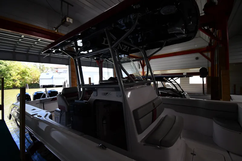 Slide: The Image of 2009 Donzi 38 ZFX Open boat in a covered dock, showcasing sleek design and seating. - 6