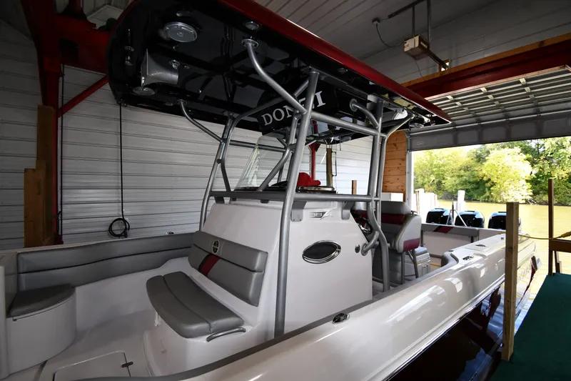 Slide: The Image of 2009 Donzi 38 ZFX Open boat docked in a covered marina. - 10