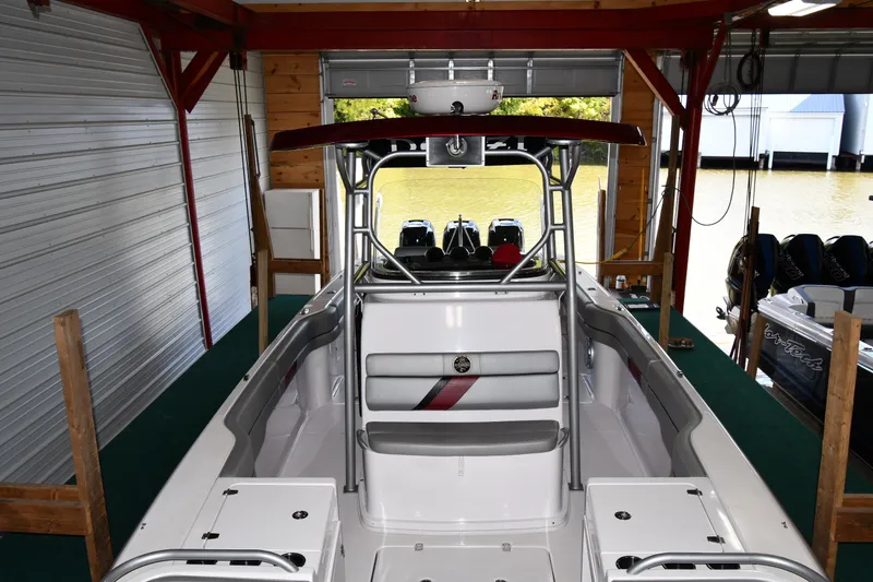 Slide: The Image of 2009 Donzi 38 ZFX Open boat docked in a covered marina, showcasing sleek interior design. - 15
