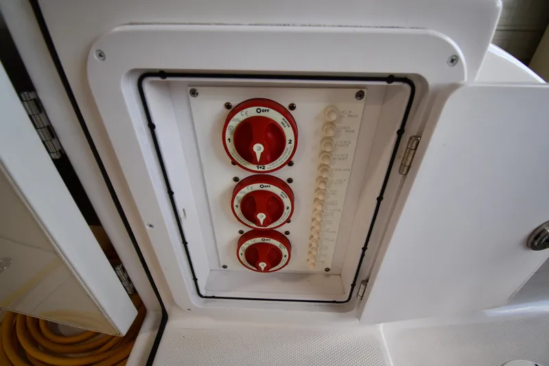 Slide: The Image of Control panel on a 2009 Donzi 38 ZFX Open boat with red switches. - 26