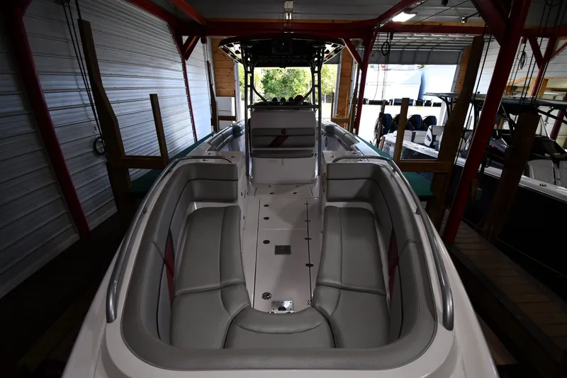Slide: The Image of 2009 Donzi 38 ZFX Open boat interior with cushioned seating in a covered dock. - 14