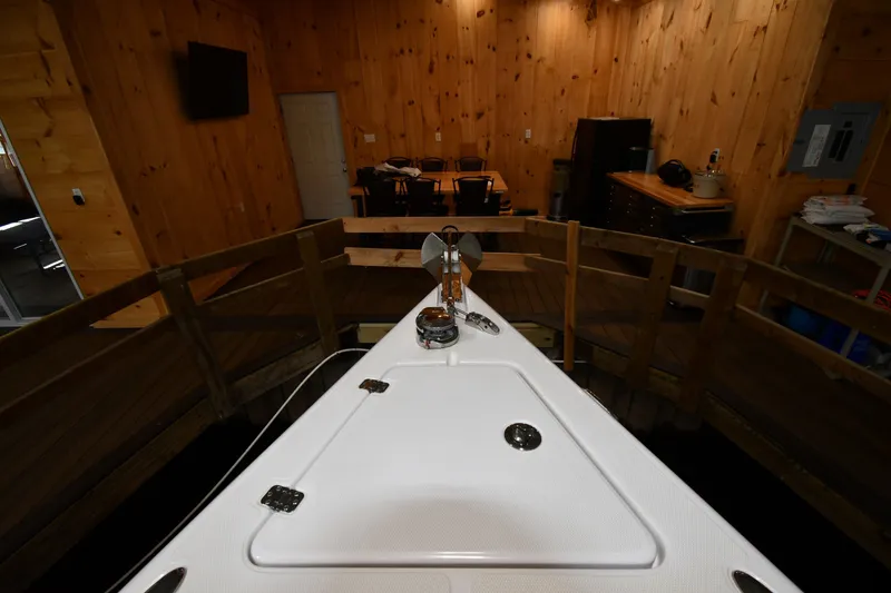 Slide: The Image of 2009 Donzi 38 ZFX Open boat docked in a wooden interior setting. - 12