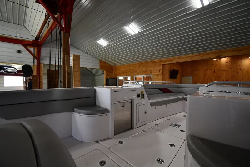 Slide: The Image of 2009 Donzi 38 ZFX Open boat interior in a wooden boathouse, featuring seating and storage. - 31