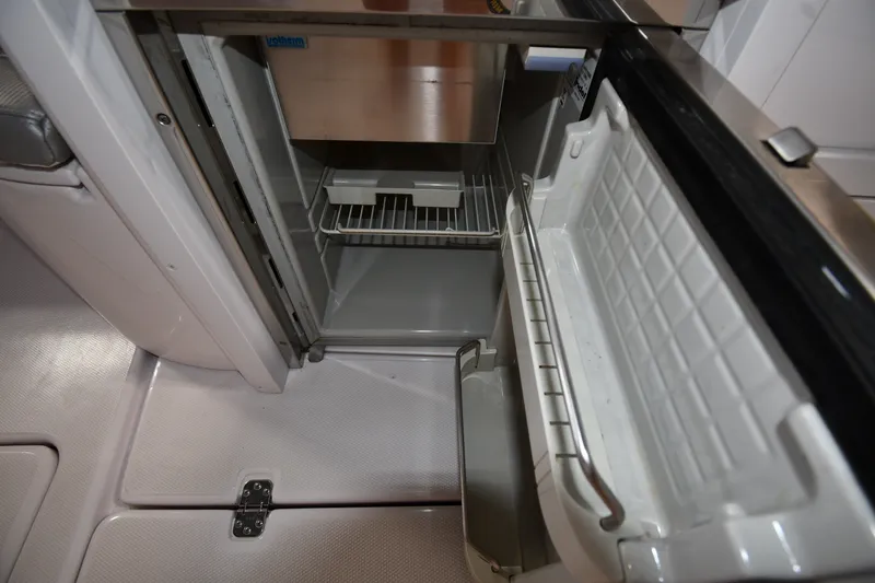 Slide: The Image of Open refrigerator inside 2009 Donzi 38 ZFX Open boat, showcasing interior storage space. - 39