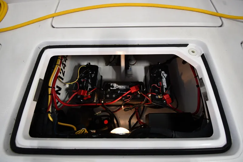 Slide: The Image of 2009 Donzi 38 ZFX Open boat battery compartment with wiring and connections. - 46