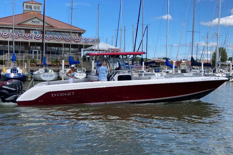 The Image of 2009 Donzi 38 ZFX Open boat docked at marina with people onboard. - 0