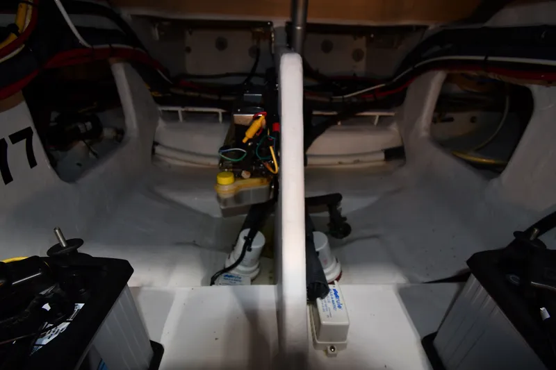 Slide: The Image of Interior view of a 2009 Donzi 38 ZFX Open boat, showcasing wiring and battery setup. - 48