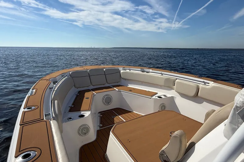 Slide: The Image of 2017 Sea Fox 328 Commander boat interior with cushioned seating on open water. - 12
