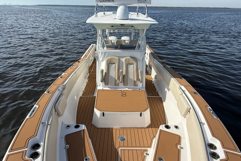 Slide: The Image of 2017 Sea Fox 328 Commander boat on calm water, featuring spacious deck and seating. - 10