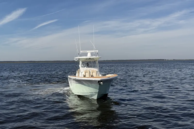 Slide: The Image of 2017 Sea Fox 328 Commander boat cruising on open water under a clear sky. - 3