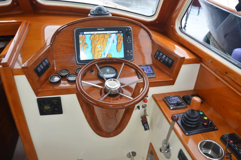 Slide: The Image of Helm of 2002 Hinckley Picnic Boat 36 EP with navigation system and wooden steering wheel. - 14
