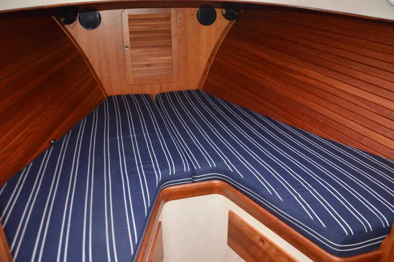 Slide: The Image of Interior cabin of 2002 Hinckley Picnic Boat 36 EP with striped cushions. - 18