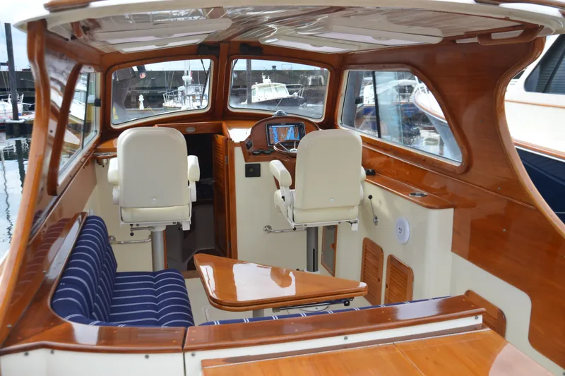 Slide: The Image of Interior of a 2002 Hinckley Picnic Boat 36 EP with polished wood and seating. - 13