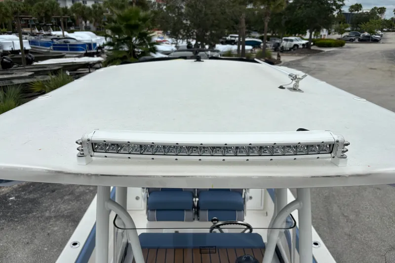 Slide: The Image of Ranger 2660 Bay 2027 boat with LED light bar on the roof, docked in a marina. - 23