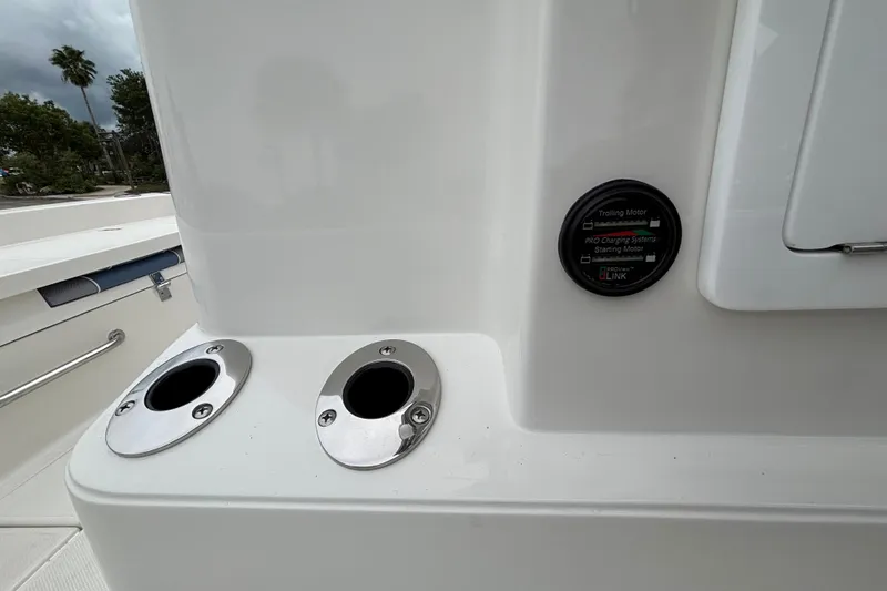 Slide: The Image of 2027 Ranger 2660 Bay boat dashboard with charging system indicator and rod holders. - 29