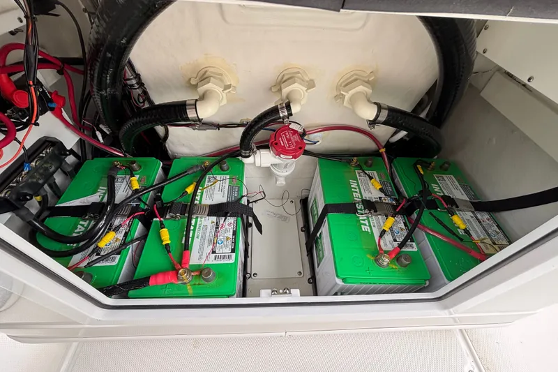 Slide: The Image of Battery compartment of 2027 Ranger 2660 Bay boat with green Interstate batteries. - 27