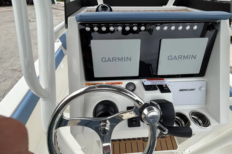 Slide: The Image of 2027 Ranger 2660 Bay boat dashboard with dual Garmin displays and Mercury controls. - 17