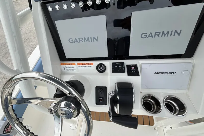 Slide: The Image of 2027 Ranger 2660 Bay boat dashboard with Garmin displays and Mercury controls. - 18