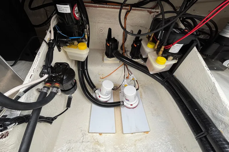 Slide: The Image of Engine compartment of 2027 Ranger 2660 Bay boat, showcasing wiring and components. - 33
