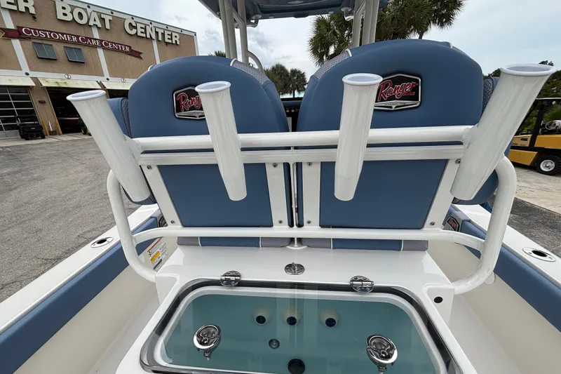 Slide: The Image of 2027 Ranger 2660 Bay boat with rod holders and livewell at a boat center. - 13