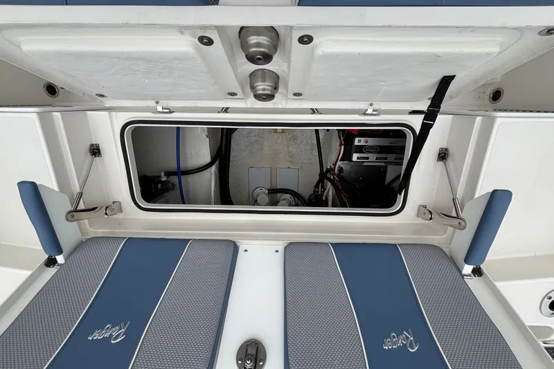 Slide: The Image of Open hatch of 2027 Ranger 2660 Bay boat showing interior storage and equipment. - 32