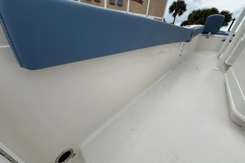 Slide: The Image of 2027 Ranger 2660 Bay boat interior with blue seating and white deck. - 14