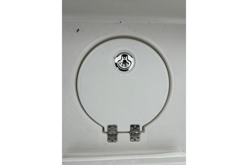 Slide: The Image of Hatch cover on 2027 Ranger 2660 Bay boat, featuring a circular design and metal latch. - 25