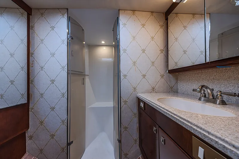 Slide: The Image of Luxurious bathroom interior of 2005 Ocean Yachts 73 Super Sport, featuring elegant fixtures and cabinetry. - 15