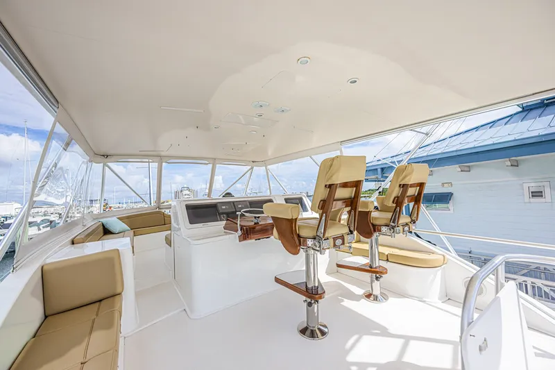 Slide: The Image of Luxurious 2005 Ocean Yachts 73 Super Sport flybridge with plush seating and helm chairs. - 8