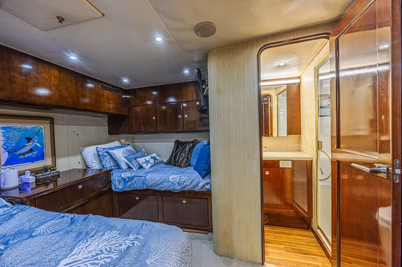 Slide: The Image of Luxurious 2005 Ocean Yachts 73 Super Sport cabin with elegant wood finishes and cozy bedding. - 17