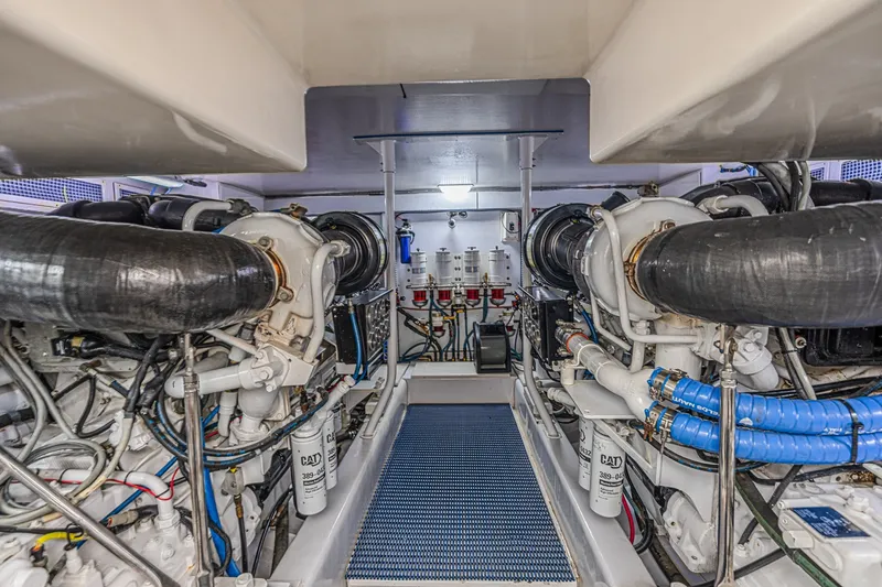 Slide: The Image of Engine room of a 2005 Ocean Yachts 73 Super Sport, showcasing dual engines and mechanical systems. - 48