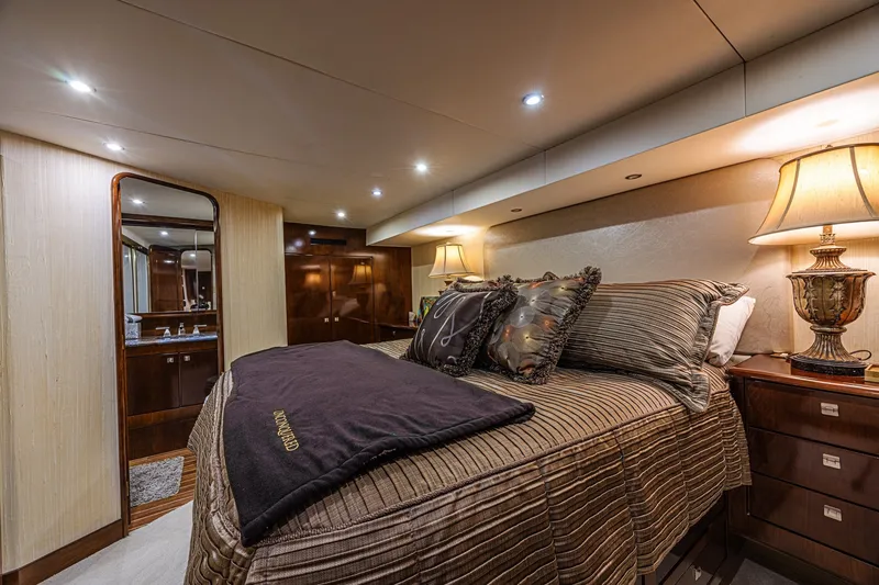 Slide: The Image of Luxurious bedroom interior of 2005 Ocean Yachts 73 Super Sport, featuring elegant decor and ambient lighting. - 24