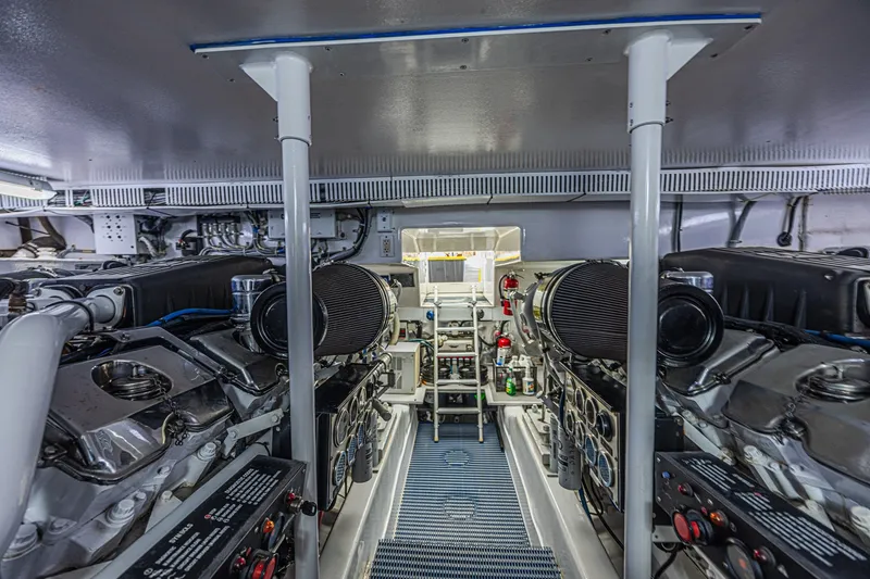 Slide: The Image of Engine room of 2005 Ocean Yachts 73 Super Sport, showcasing dual engines and equipment. - 47