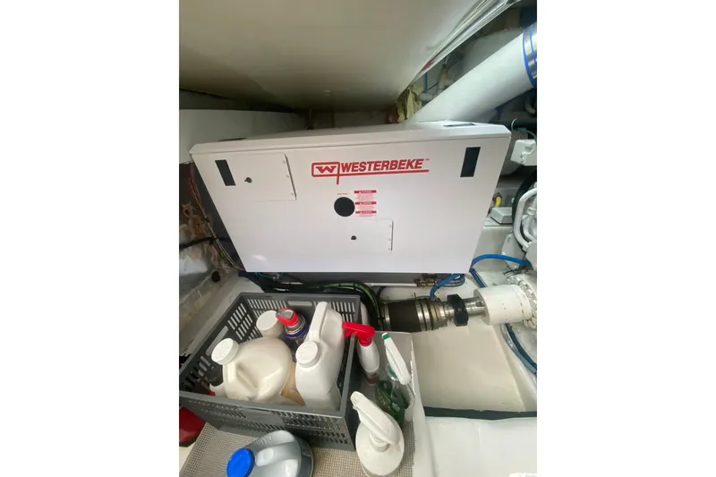 Slide: The Image of Engine room of 2005 Ocean Yachts 73 Super Sport with Westerbeke generator and maintenance supplies. - 42