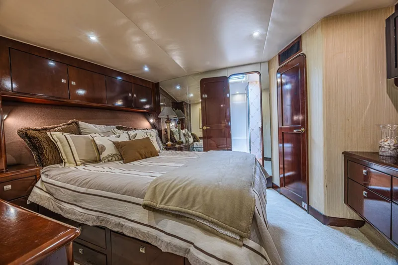 Slide: The Image of Luxurious bedroom interior of 2005 Ocean Yachts 73 Super Sport, featuring elegant wood finishes. - 13