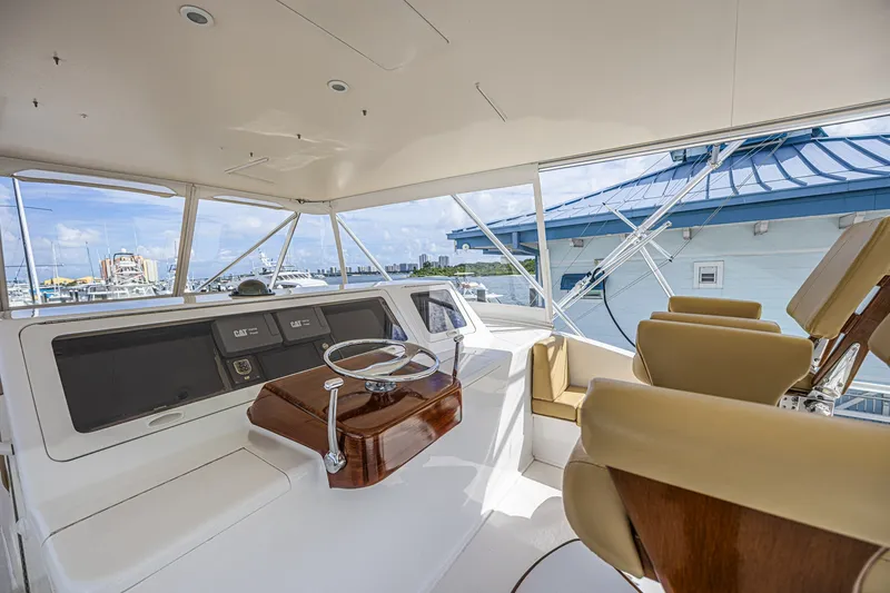 Slide: The Image of Interior view of 2005 Ocean Yachts 73 Super Sport helm with leather seats and steering wheel. - 9