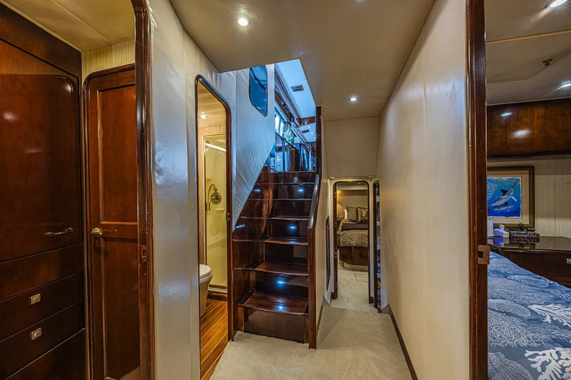 Slide: The Image of Luxurious interior of 2005 Ocean Yachts 73 Super Sport with elegant wood finishes and staircase. - 20