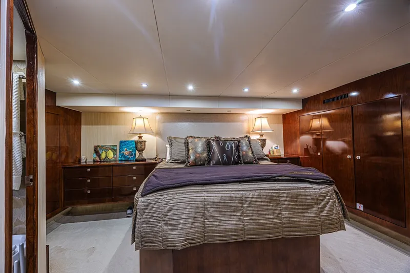Slide: The Image of Luxurious bedroom interior of 2005 Ocean Yachts 73 Super Sport with elegant wood finishes. - 23