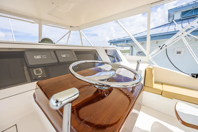 Slide: The Image of Helm of 2005 Ocean Yachts 73 Super Sport with polished wood and chrome details. - 10