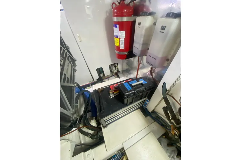 Slide: The Image of Engine room of 2005 Ocean Yachts 73 Super Sport with fire extinguisher and equipment. - 38