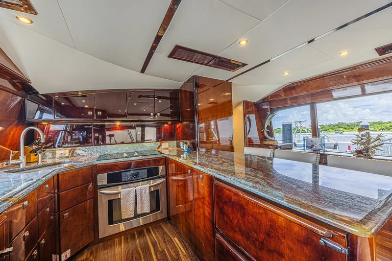 Slide: The Image of Luxurious kitchen interior of 2005 Ocean Yachts 73 Super Sport with elegant wood finishes. - 28