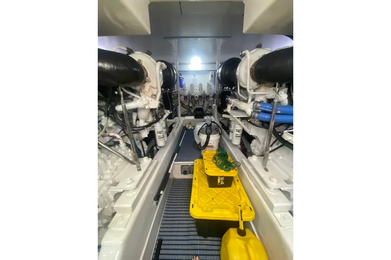 Slide: The Image of Engine room of 2005 Ocean Yachts 73 Super Sport, showcasing dual engines and equipment. - 46