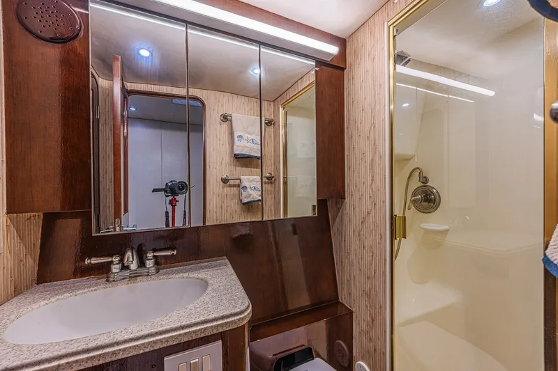 Slide: The Image of Luxurious bathroom in 2005 Ocean Yachts 73 Super Sport with shower and vanity. - 21