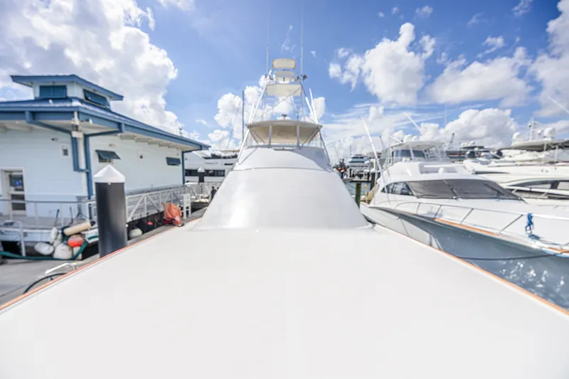 Slide: The Image of 2005 Ocean Yachts 73 Super Sport docked at marina under blue sky. - 7